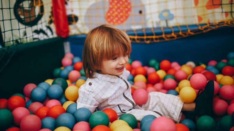 A child in the ball pit of a children's play room