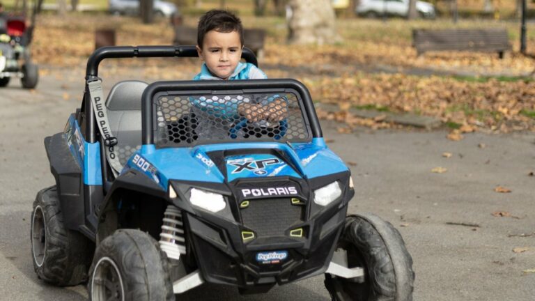 A child at the wheel of a kids' electric car