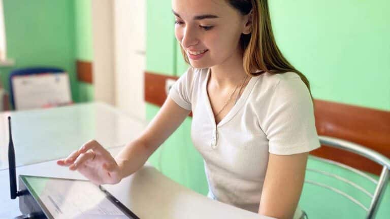 An employee at a point working with RentOS on a tablet